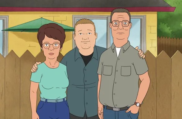 An older Peggy, Bobby, and Hank pose in front of their fence.
